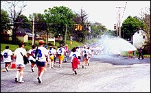 Local fire departments help  combat the 90+ degree heat by spraying walkers as they walk by.