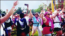 After conquering 60 miles, walkers joyfully cross the finish line.